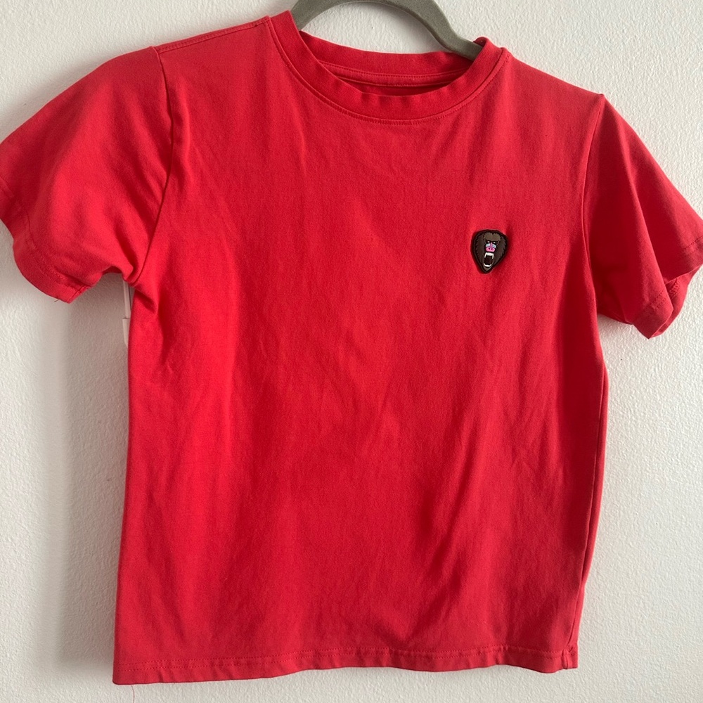 Mad Chuck T shirt. Bright coral color with rubber monkey logo on front.